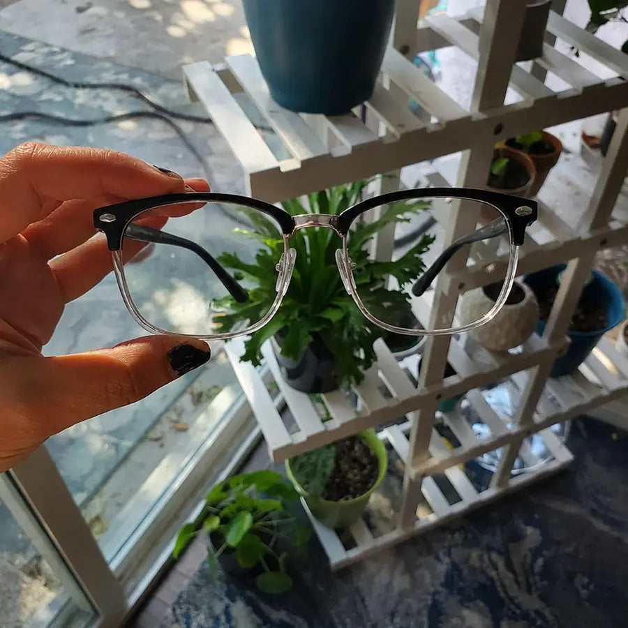 Robert keeps spare blue-light reading glasses near desk and living room